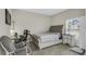 Bedroom featuring a desk, office chair, an upholstered bed, and a gray stool at 1821 Benevento St, St Cloud, FL 34771