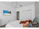 Comfortable bedroom with large closet, wall-mounted television, and soft carpet at 1821 Benevento St, St Cloud, FL 34771