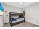 Bedroom with a full bunk bed, carpeting, ceiling fan, and a window at 1821 Benevento St, St Cloud, FL 34771