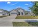 Charming one-story home featuring manicured lawn and a two-car garage at 1821 Benevento St, St Cloud, FL 34771