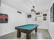 Game room featuring pool table, window, and baseball-themed wall art at 1821 Benevento St, St Cloud, FL 34771
