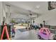 Spacious garage used as a play area and home gym with open garage door at 1821 Benevento St, St Cloud, FL 34771