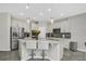 Kitchen island with quartz countertop, stainless steel appliances, and dining area at 1821 Benevento St, St Cloud, FL 34771