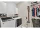 Laundry room with modern washer, dryer, storage, and clothing rack at 1821 Benevento St, St Cloud, FL 34771