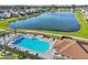 Aerial view of a community pool, lake, and homes in the neighborhood at 1821 Benevento St, St Cloud, FL 34771