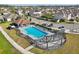 Aerial view of a community pool with lounge chairs, pergola, and surrounding neighborhood at 1821 Benevento St, St Cloud, FL 34771