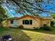 Single-story home with an inviting backyard featuring a fire pit and partially shaded grassy area at 2 Clear Pl, Ocala, FL 34472