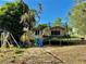 Backyard featuring a trampoline, play set, and partially shaded grassy area at 2 Clear Pl, Ocala, FL 34472