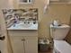 Practical bathroom showcasing a vanity with storage, a toilet, and tiled accents at 2 Clear Pl, Ocala, FL 34472