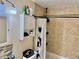 The bathroom features tile walls, a shower-tub combo, and a sleek vanity with storage at 2 Clear Pl, Ocala, FL 34472