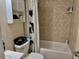 This bathroom features tile walls, a shower-tub combo, and a vanity with storage at 2 Clear Pl, Ocala, FL 34472