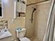Bathroom with shower and commode with storage cabinet above at 2 Clear Pl, Ocala, FL 34472
