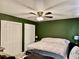 Bedroom with green walls, a ceiling fan with lights, and carpeted flooring at 2 Clear Pl, Ocala, FL 34472