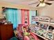This bedroom features colorful decor, bunk beds, and cheerful curtains at 2 Clear Pl, Ocala, FL 34472