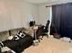 A comfortable bedroom with a couch, desk, and tile flooring, suitable for relaxation and study at 2 Clear Pl, Ocala, FL 34472