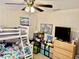 Cozy bedroom featuring a bunk bed, ceiling fan, and playful decor at 2 Clear Pl, Ocala, FL 34472