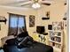 Comfortable bedroom featuring ceiling fan, comic book decor, and abundant natural light from window at 2 Clear Pl, Ocala, FL 34472