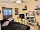 Charming bedroom with comic book decor, a ceiling fan, and a view of the backyard at 2 Clear Pl, Ocala, FL 34472