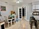 View of dining area with white chairs and tiled floor, plus open doorway and kitchen counter at 2 Clear Pl, Ocala, FL 34472