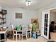 Cozy dining area with round table and white chairs, brightened by natural light from the doorway at 2 Clear Pl, Ocala, FL 34472