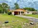 Classic one-story home boasts a covered carport and lush green lawn at 2 Clear Pl, Ocala, FL 34472