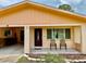 Inviting one-story home with a covered carport, featuring a cozy front porch area at 2 Clear Pl, Ocala, FL 34472