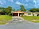 Charming one-story home features a covered carport and a well-maintained front lawn at 2 Clear Pl, Ocala, FL 34472