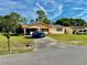 Inviting single-story home with an open carport and driveway, complemented by a green lawn at 2 Clear Pl, Ocala, FL 34472