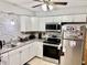 Updated kitchen with stainless steel appliances and updated countertops and backsplash at 2 Clear Pl, Ocala, FL 34472