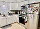 Updated kitchen with stainless steel appliances, granite counters, and bright white cabinetry at 2 Clear Pl, Ocala, FL 34472