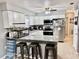 Modern kitchen featuring a breakfast bar, white cabinets, and stainless steel appliances at 2 Clear Pl, Ocala, FL 34472