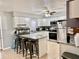 Well-lit kitchen with white cabinets, stainless steel appliances, and a breakfast bar at 2 Clear Pl, Ocala, FL 34472