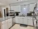 Updated kitchen with white cabinets, stainless steel dishwasher, and granite countertops at 2 Clear Pl, Ocala, FL 34472