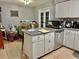 Spacious kitchen featuring a center island with granite countertop and stainless steel appliances at 2 Clear Pl, Ocala, FL 34472