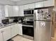 Bright kitchen featuring stainless steel appliances and modern white cabinetry at 2 Clear Pl, Ocala, FL 34472