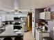 Updated kitchen with stainless steel appliances, granite counters, and white cabinetry at 2 Clear Pl, Ocala, FL 34472