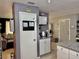 Kitchen with granite countertops, white cabinets, and a view into the living room at 2 Clear Pl, Ocala, FL 34472