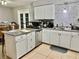 Updated kitchen featuring white cabinets, granite countertops and stainless steel dishwasher at 2 Clear Pl, Ocala, FL 34472