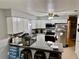 Bright kitchen with white cabinets, a stainless steel refrigerator, and a granite countertop island at 2 Clear Pl, Ocala, FL 34472