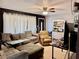 Inviting living room with a sectional sofa, accent wall, and neutral tile flooring at 2 Clear Pl, Ocala, FL 34472