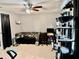 Open concept living room with lots of natural light, ceiling fan, and gray tiled flooring at 2 Clear Pl, Ocala, FL 34472