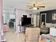 Open-concept living area featuring tile floors, modern lighting, and a view into the kitchen at 2 Clear Pl, Ocala, FL 34472