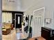 Inviting living room with a cozy armchair, dark accent wall, and neutral tile flooring at 2 Clear Pl, Ocala, FL 34472
