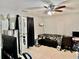 Bright living room with neutral paint, ceiling fan and sliding door to the outdoors at 2 Clear Pl, Ocala, FL 34472