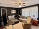 Comfortable living room with an L-shaped sofa, ceiling fan, and neutral tile floors at 2 Clear Pl, Ocala, FL 34472