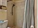 Bathroom featuring commode and walk-in shower with shower curtain at 2 Clear Pl, Ocala, FL 34472