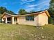 A single-story home with a brick facade, solar panels, and a view into the open carport at 2 Clear Pl, Ocala, FL 34472