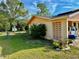 Charming exterior showcasing decorative blockwork, landscaping, and a peek into the open carport at 2 Clear Pl, Ocala, FL 34472