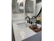 Bathroom vanity featuring quartz countertop, a round mirror, and modern faucet at 2049 Crosscreek Ct, Oviedo, FL 32766