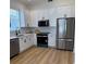 Well-equipped kitchen with stainless steel appliances, white cabinets, and modern fixtures at 2049 Crosscreek Ct, Oviedo, FL 32766